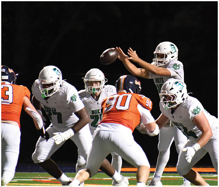 A group of football players on a field. Description generated by AI