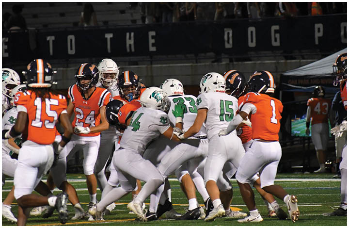 A group of football players on a field. Description generated by AI