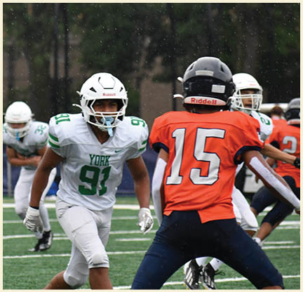 A football player is kicking a football on a field. Description generated by AI
