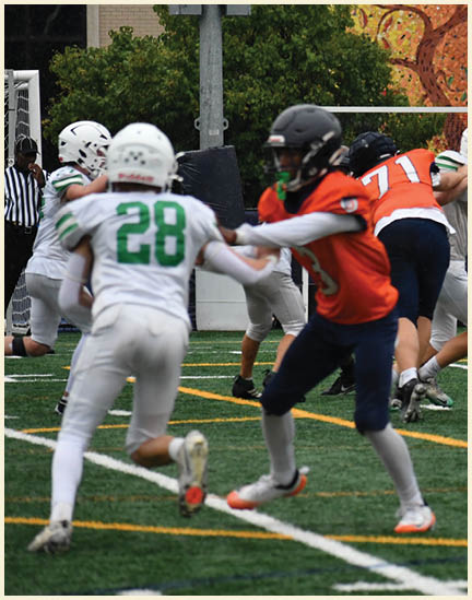 A football player wearing a black jersey with the number 11 on it. Description generated by AI