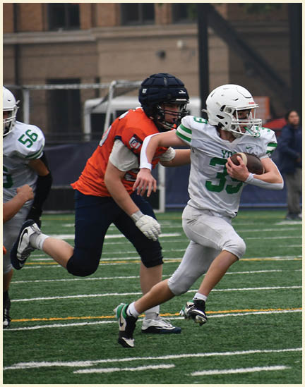 A football player wearing a black jersey with the number 11 on it. Description generated by AI