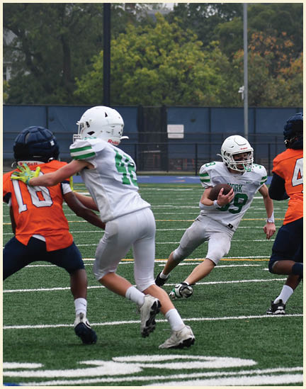 A football player wearing a black jersey with the number 11 on it. Description generated by AI