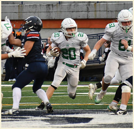 A football player is kicking a football on a field. Description generated by AI