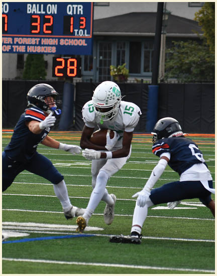 A football player wearing a black jersey with the number 11 on it. Description generated by AI