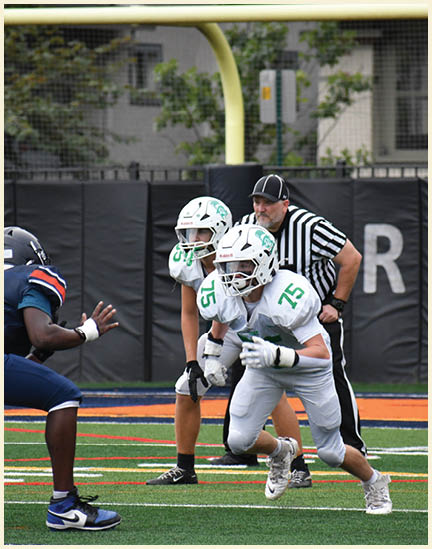 A football player wearing a black jersey with the number 11 on it. Description generated by AI