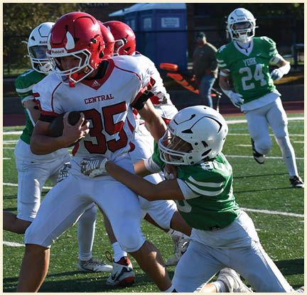 A football player is kicking a football on a field. Description generated by AI