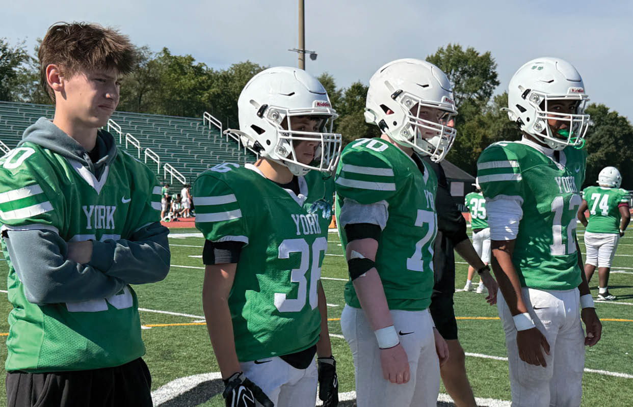 A group of people wearing black and white uniforms. Description generated by AI