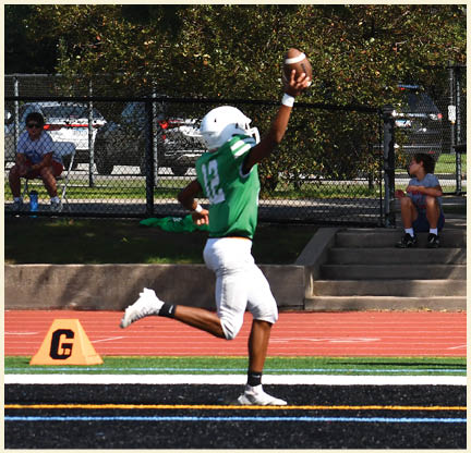 A football player is kicking a football on a field. Description generated by AI