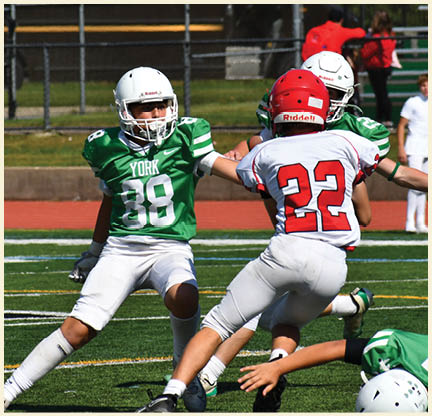 A football player is kicking a football on a field. Description generated by AI