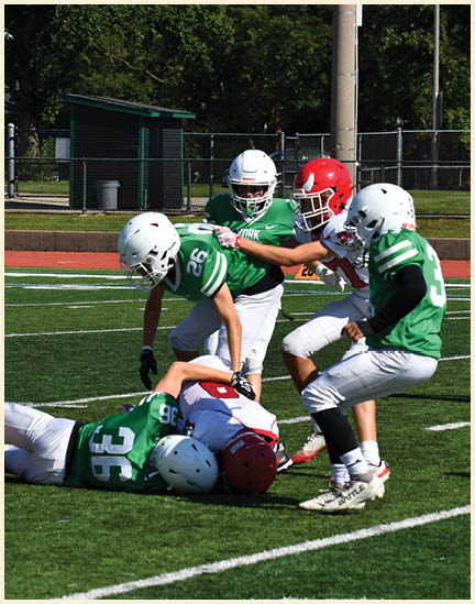 A football player wearing a black jersey with the number 11 on it. Description generated by AI