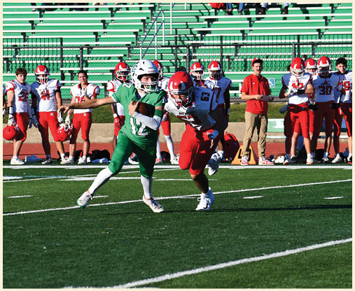 A football player is kicking a football on a field. Description generated by AI