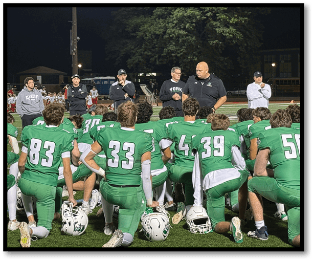 A group of football players wearing black jerseys with the number 3 on them. Description generated by AI