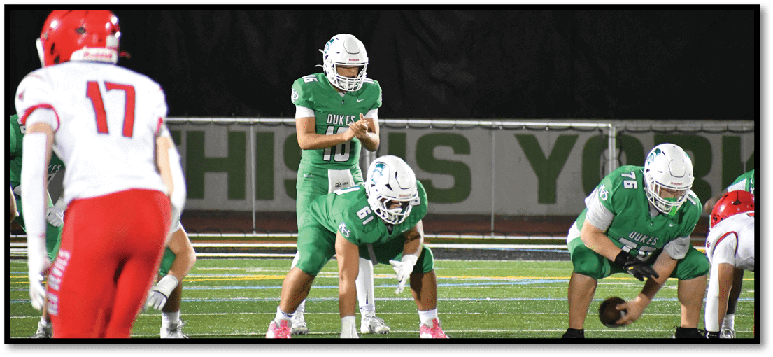 A group of football players on a field. Description generated by AI