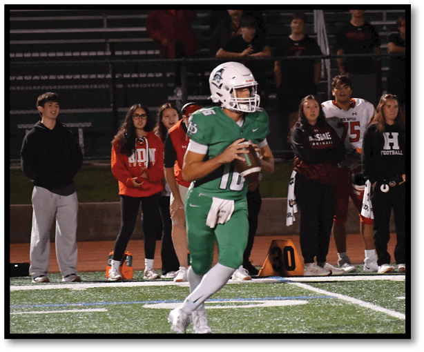 A football player is kicking a football on a field. Description generated by AI