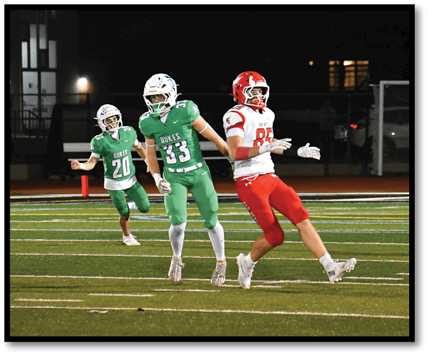 A football player is kicking a football on a field. Description generated by AI