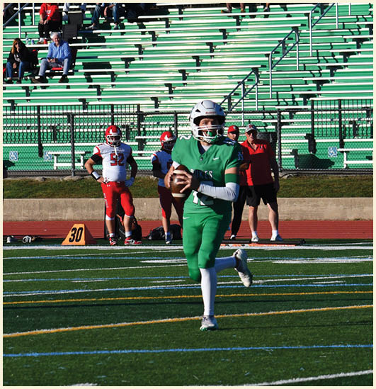 A football player wearing a black jersey with the number 11 on it. Description generated by AI