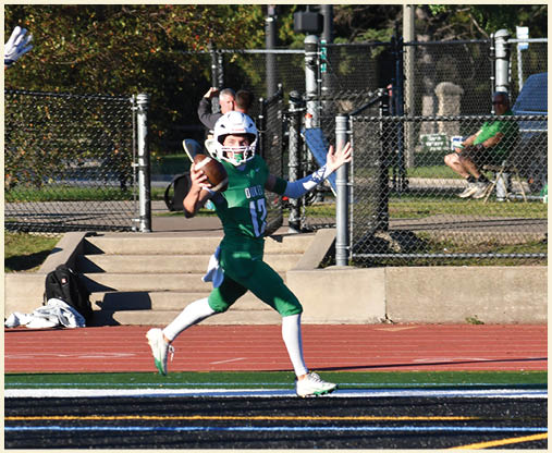 A football player is kicking a football on a field. Description generated by AI