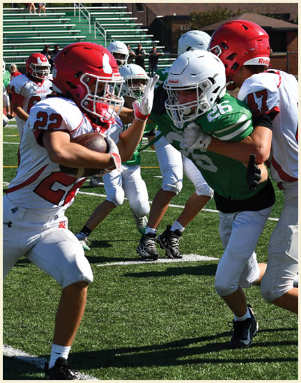 A football player wearing a black jersey with the number 11 on it. Description generated by AI