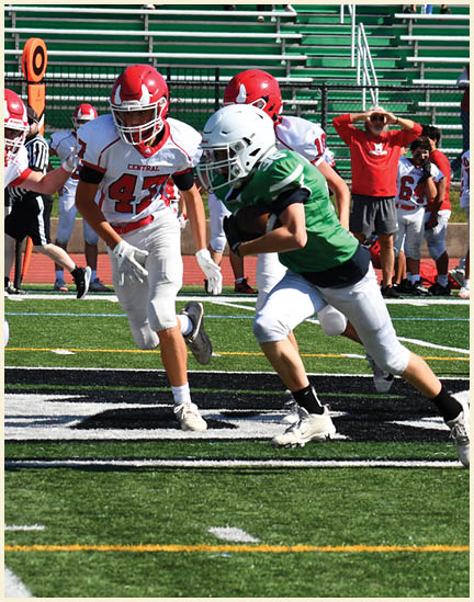 A football player wearing a black jersey with the number 11 on it. Description generated by AI