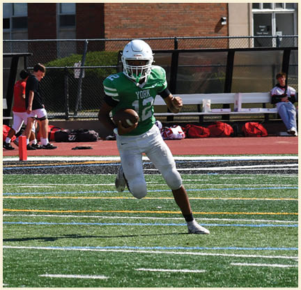 A football player is kicking a football on a field. Description generated by AI