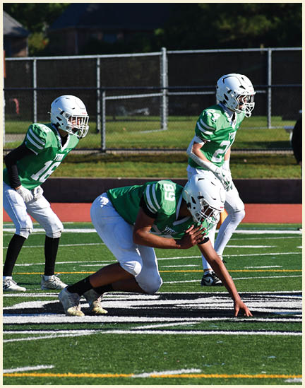 A football player wearing a black jersey with the number 11 on it. Description generated by AI