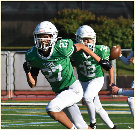 A football player is kicking a football on a field. Description generated by AI