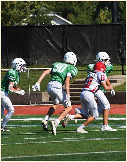 A football player wearing a black jersey with the number 11 on it. Description generated by AI