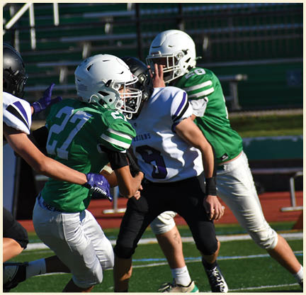 A football player is kicking a football on a field. Description generated by AI
