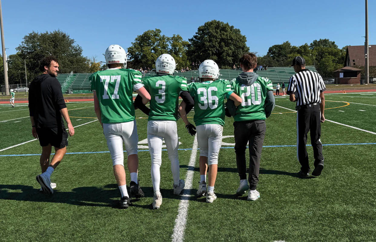 A group of people wearing black and white uniforms. Description generated by AI