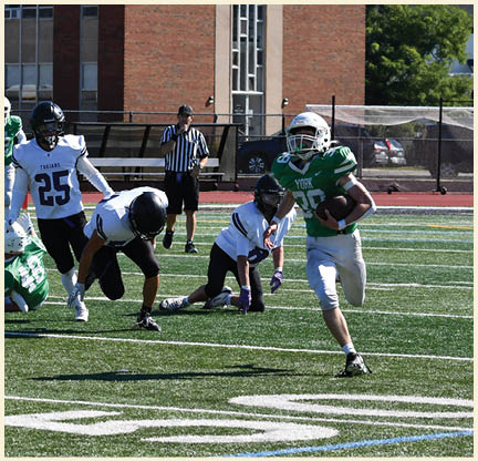 A football player is kicking a football on a field. Description generated by AI