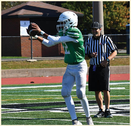 A football player is kicking a football on a field. Description generated by AI