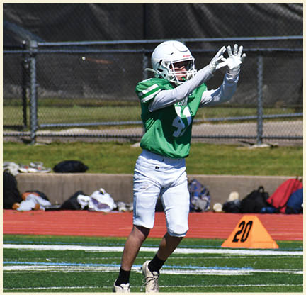A football player is kicking a football on a field. Description generated by AI