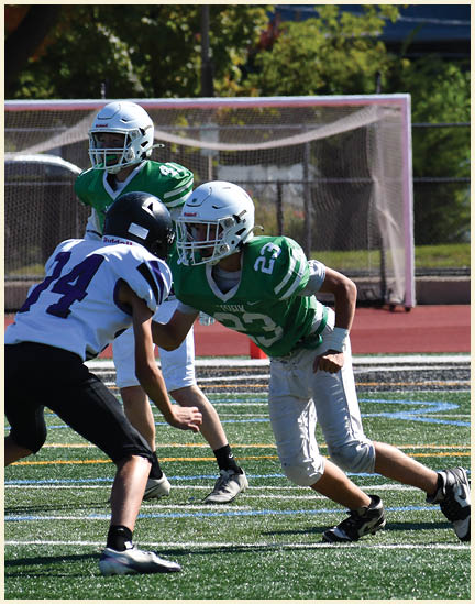 A football player wearing a black jersey with the number 11 on it. Description generated by AI