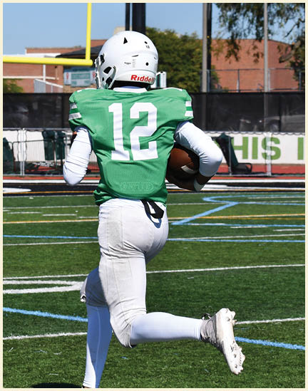 A football player wearing a black jersey with the number 11 on it. Description generated by AI