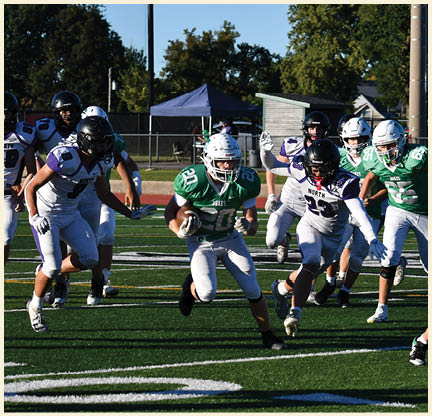 A football player is kicking a football on a field. Description generated by AI