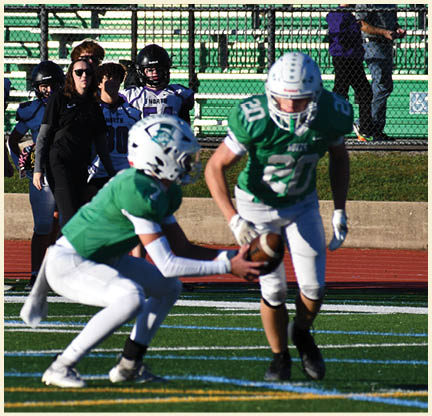 A football player is kicking a football on a field. Description generated by AI