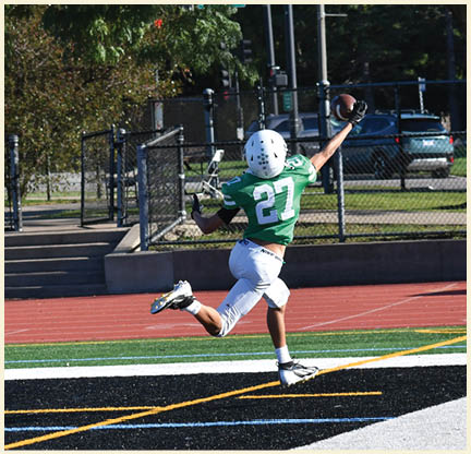 A football player is kicking a football on a field. Description generated by AI