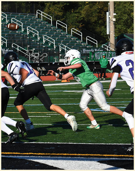 A football player wearing a black jersey with the number 11 on it. Description generated by AI