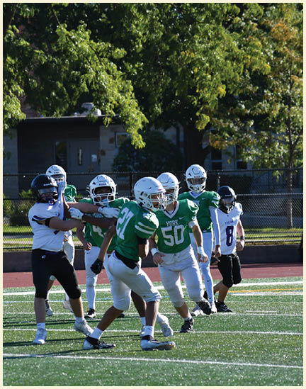 A football player wearing a black jersey with the number 11 on it. Description generated by AI