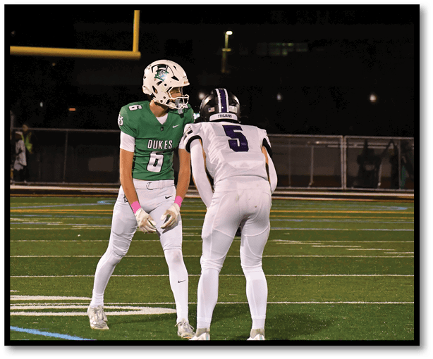 A football player is kicking a football on a field. Description generated by AI