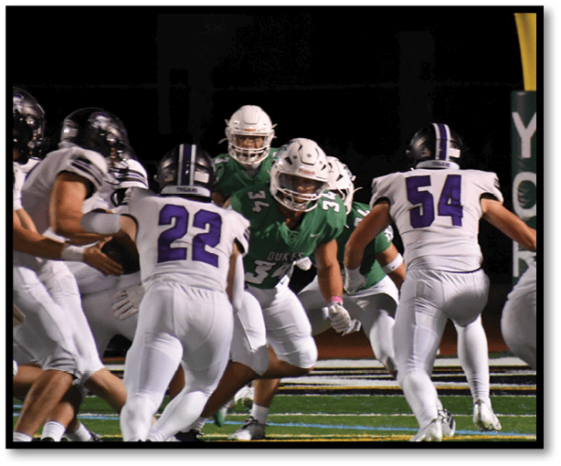 A group of football players wearing black jerseys with the number 3 on them. Description generated by AI