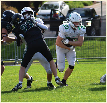 A football player wearing a black jersey with the number 11 on it. Description generated by AI