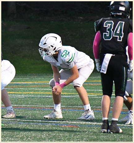 A football player wearing a black jersey with the number 11 on it. Description generated by AI