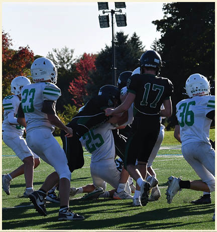 A football player wearing a black jersey with the number 11 on it. Description generated by AI