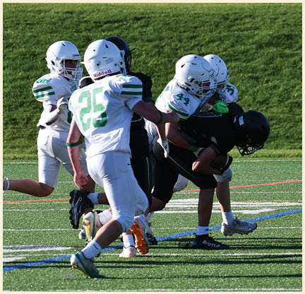 A football player wearing a black jersey with the number 11 on it. Description generated by AI