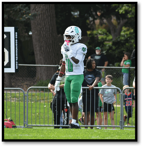 Two football players wearing black jerseys with the number 11 on them. Description generated by AI