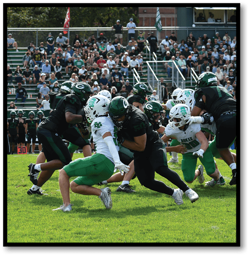 A football player wearing a black jersey with the number 6 on it. Description generated by AI