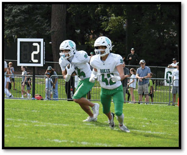 A football player is kicking a football on a field. Description generated by AI