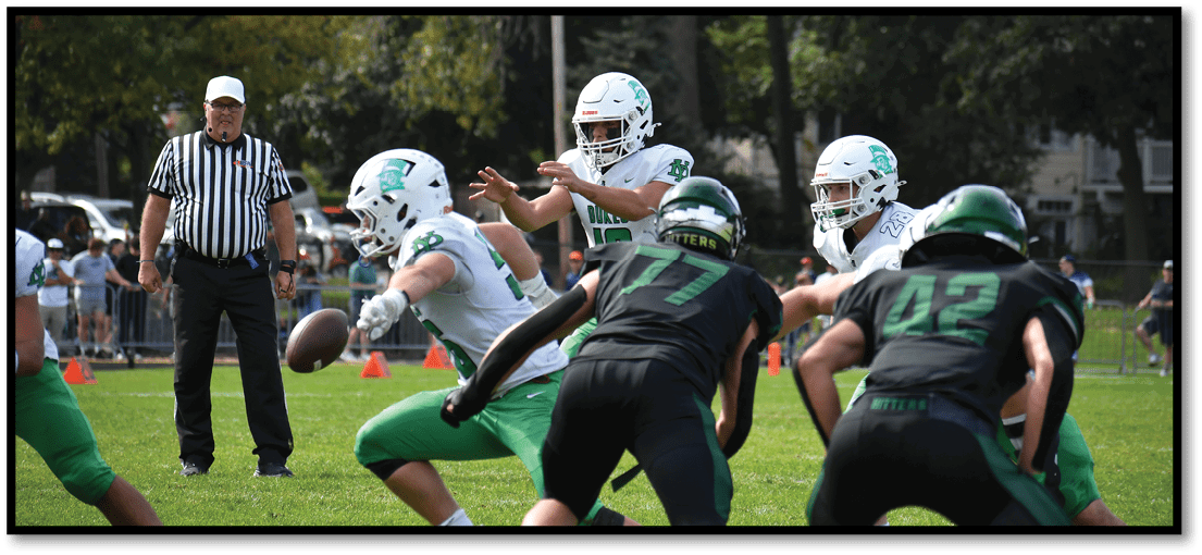 A group of football players on a field. Description generated by AI