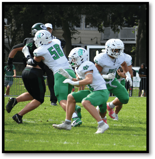 A group of men wearing black and white jerseys. Description generated by AI